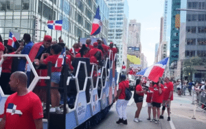 Dominican Day Parade participants marching along Sixth Avenue in New York