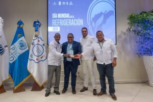 Technicians demonstrating environmentally friendly CO2 refrigeration technology