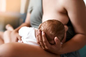 Mother breastfeeding infant during World Breastfeeding Week