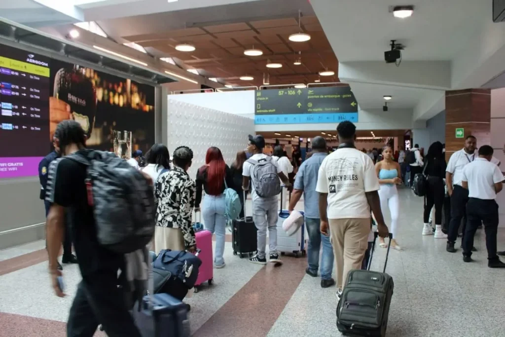 Passengers looking for airline check-in counters inside AILA