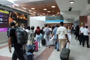 Passengers looking for airline check-in counters inside AILA