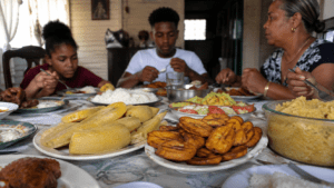 Dominican family meal featuring boiled, fried, and mashed plantains on a dining table