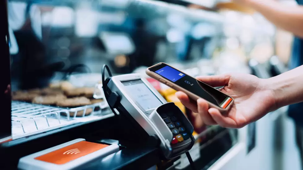 Customer making a contactless payment with a smartphone