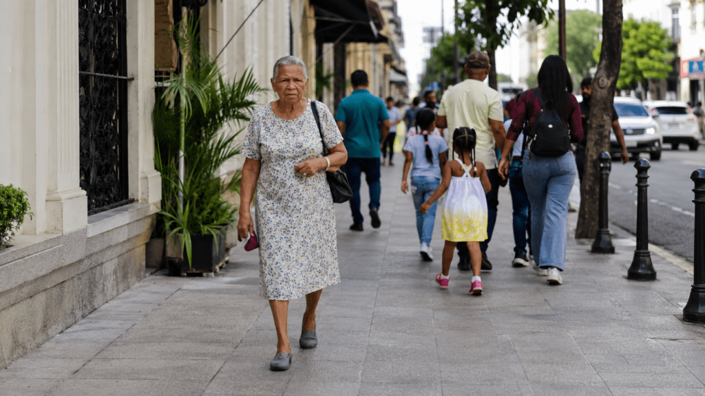 Older Dominican woman walking through a Santo Domingo