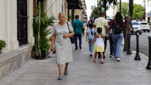 Older Dominican woman walking through a Santo Domingo