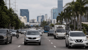 Vehicles traveling through a modern urban roadway in the Dominican Republic, representing the country's automotive industry