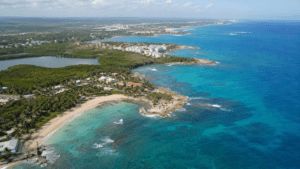 Aerial view of the Dominican Republic coastline showing beaches, turquoise water, vegetation and developed coastal areas