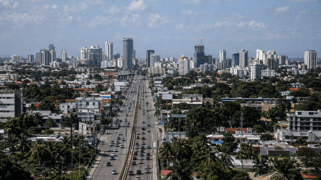 Santo Domingo skyline with modern commercial buildings, major roads and urban infrastructure representing the Dominican Republic’s economic growth and development challenges