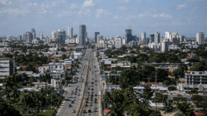 Santo Domingo skyline with modern commercial buildings, major roads and urban infrastructure representing the Dominican Republic’s economic growth and development challenges