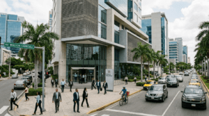Modern skyline of Santo Domingo with a prominent Dominican bank branch representing the country's banking sector.