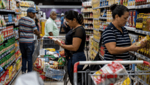 Dominican shoppers comparing grocery prices in a supermarket