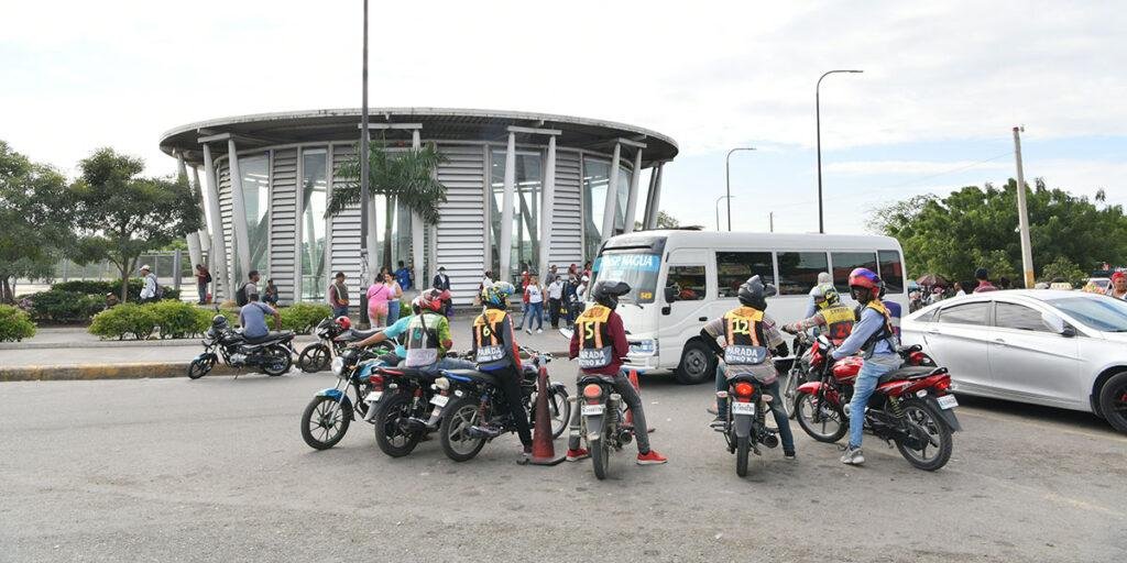 Motoconchistas waiting for passengers at a motorcycle taxi stand in Santo Domingo, Dominican Republic