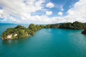 A panoramic view of Los Haitises National Park showcasing limestone islands, mangrove forests, and turquoise waters in the Dominican Republic.