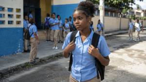 Dominican teenage girl walking outside a public secondary school in the Dominican Republic
