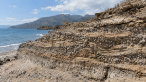 Geologists examining ancient earthquake-induced liquefaction structures preserved in coastal sediments at Tortuguero Beach in Ocoa Bay, Dominican Republic