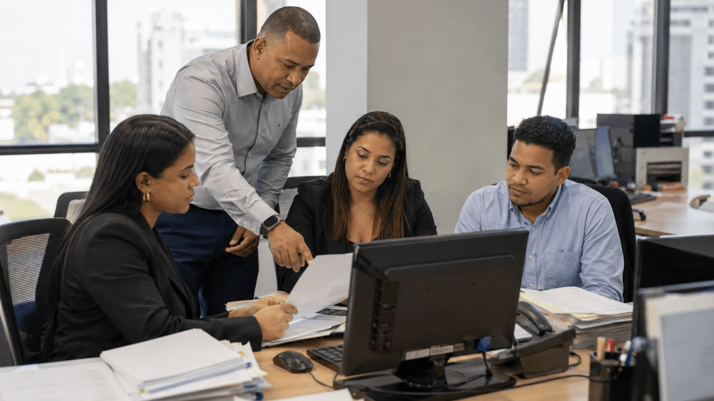 Dominican employees and employer representatives handling social security and payroll records