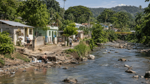 Semi-rural community in Espaillat province, Dominican Republic, beside a freshwater stream surrounded by tropical vegetation and modest homes