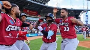 Jefferson Rojas celebrates after hitting a home run for the Gigantes del Cibao against the Tigres del Licey