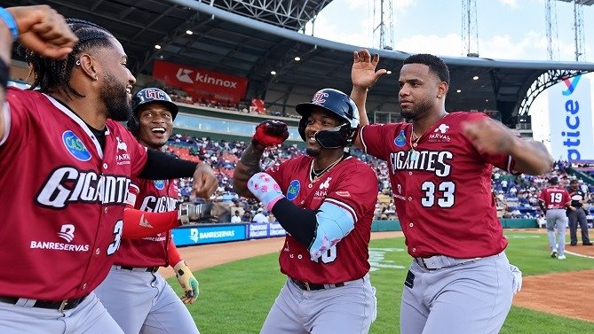 Jefferson Rojas celebrates after hitting a home run for the Gigantes del Cibao against the Tigres del Licey